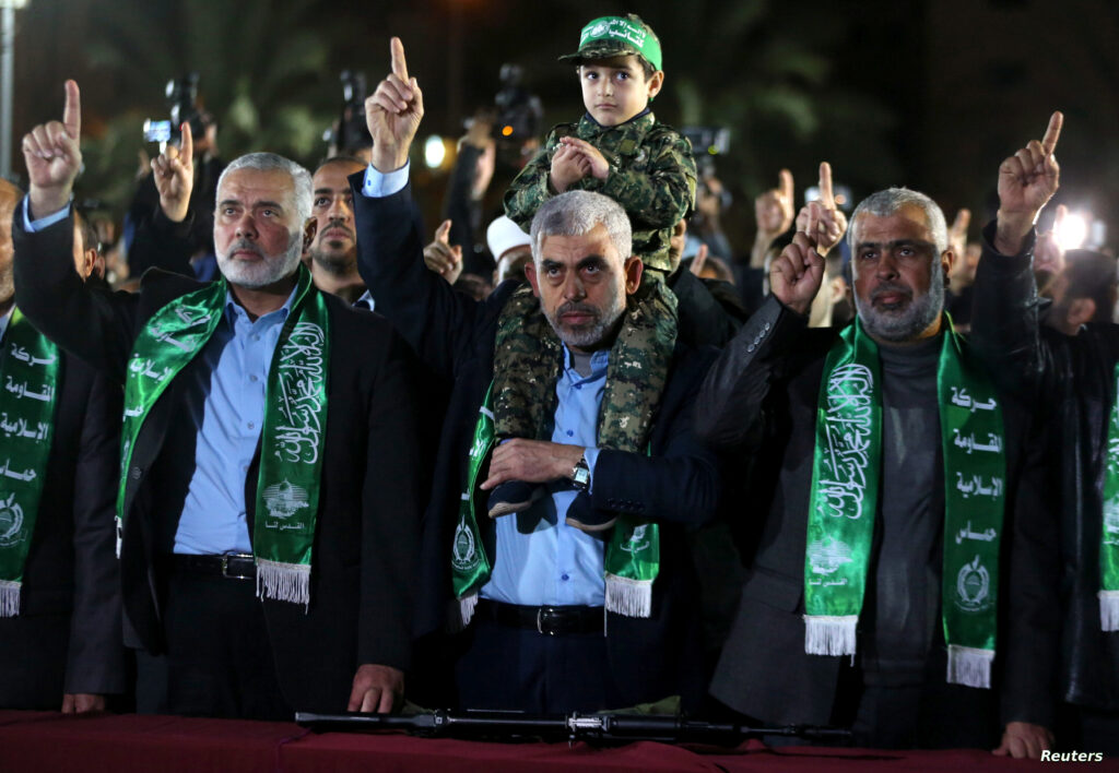 Son of senior Hamas militant Mazen Fuqaha sits on the shoulders of Hamas Gaza Chief Yehya Al-Sinwar during a memorial service for Fuqaha, in Gaza City