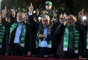 Son of senior Hamas militant Mazen Fuqaha sits on the shoulders of Hamas Gaza Chief Yehya Al-Sinwar during a memorial service for Fuqaha, in Gaza City